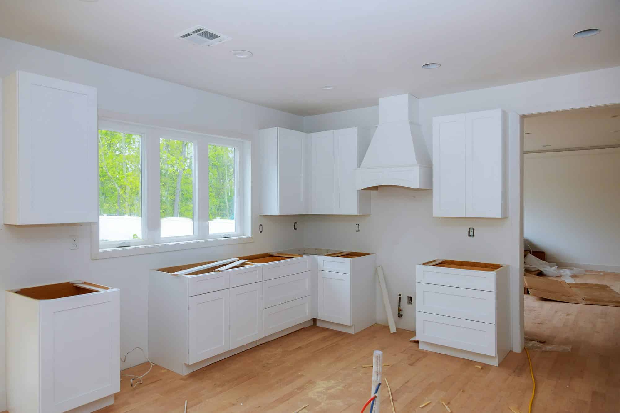 Interior design construction of kitchen with cabinet maker installing custom