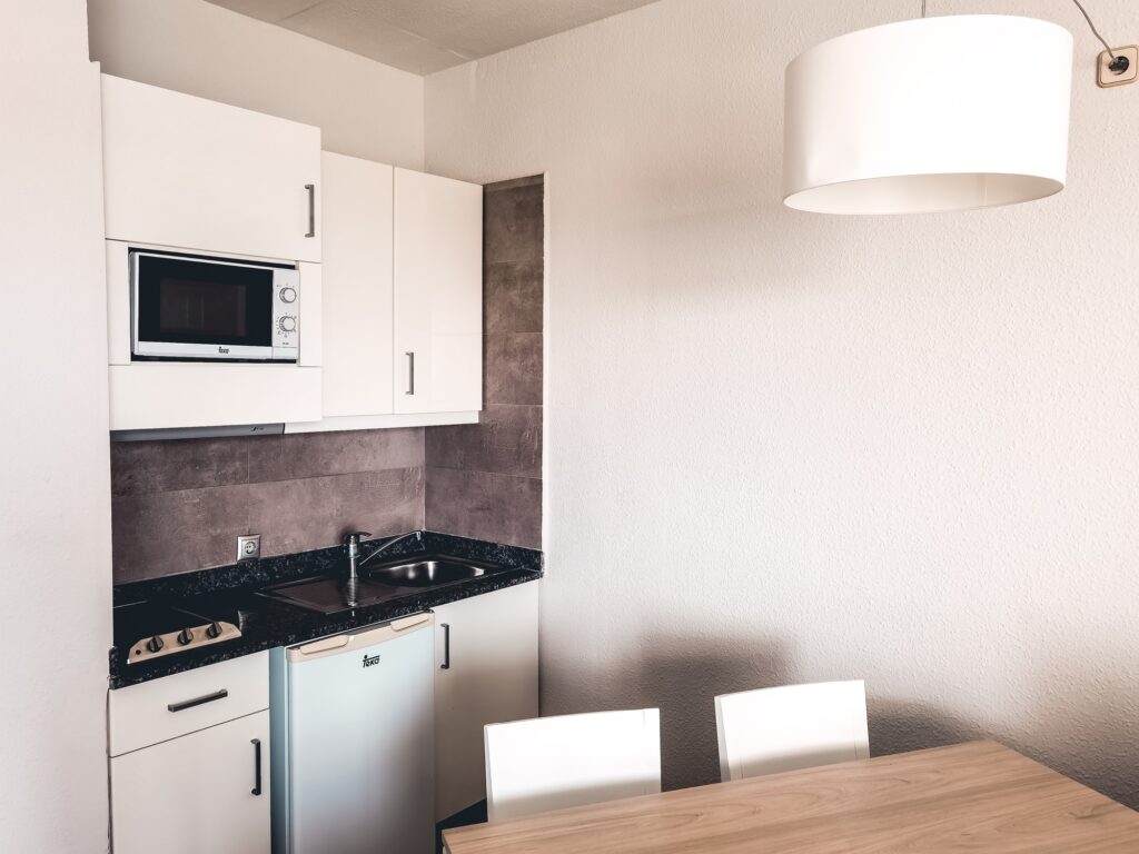 Apartament with small kitchen, modern interior design, hotel, summertime
