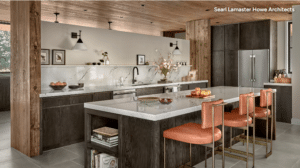 Open-concept kitchen with dark wood cabinets, a light marble island, and orange bar stools under exposed wood beams.