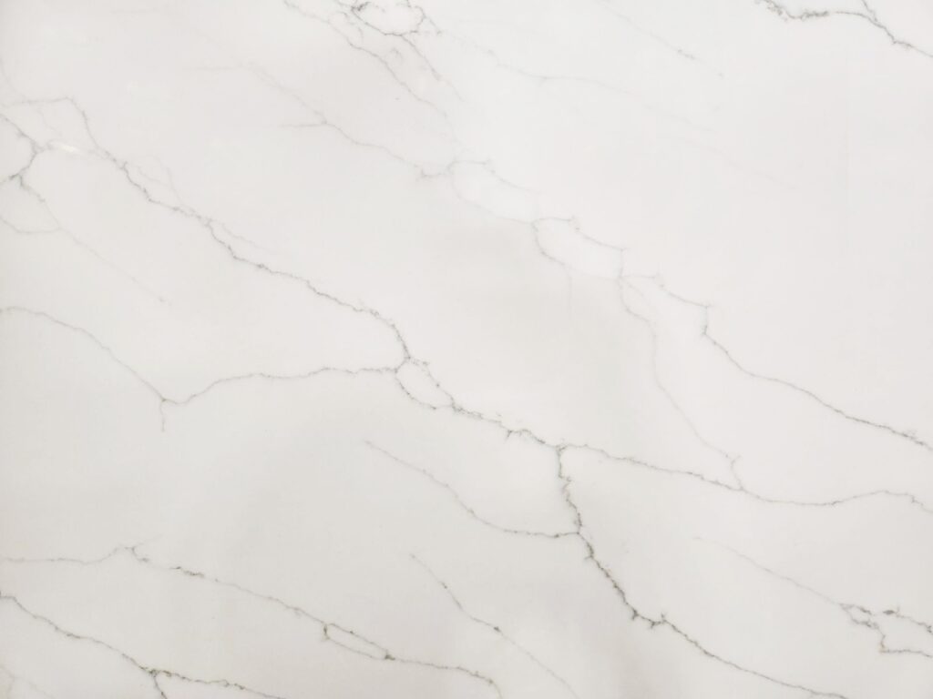 White marble slab with light gray veining and subtle texture throughout.