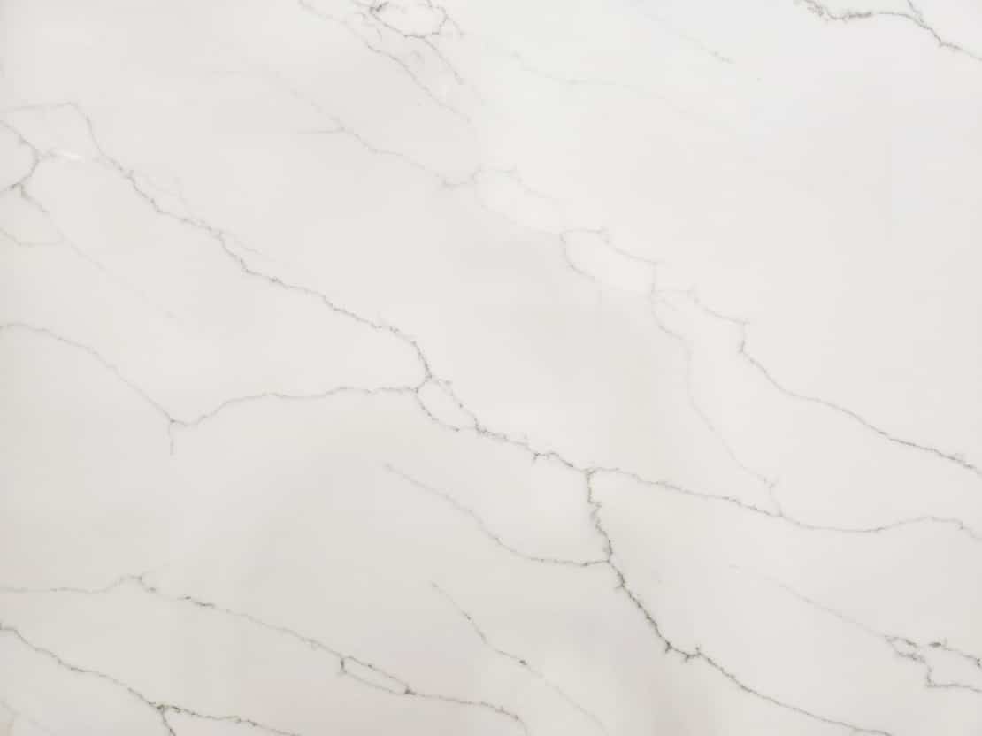 White marble slab with light gray veining and subtle texture throughout.