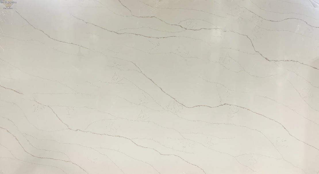 White marble slab with pale gray veining and a small Vision Quartz Exclusive logo in the top-left corner.