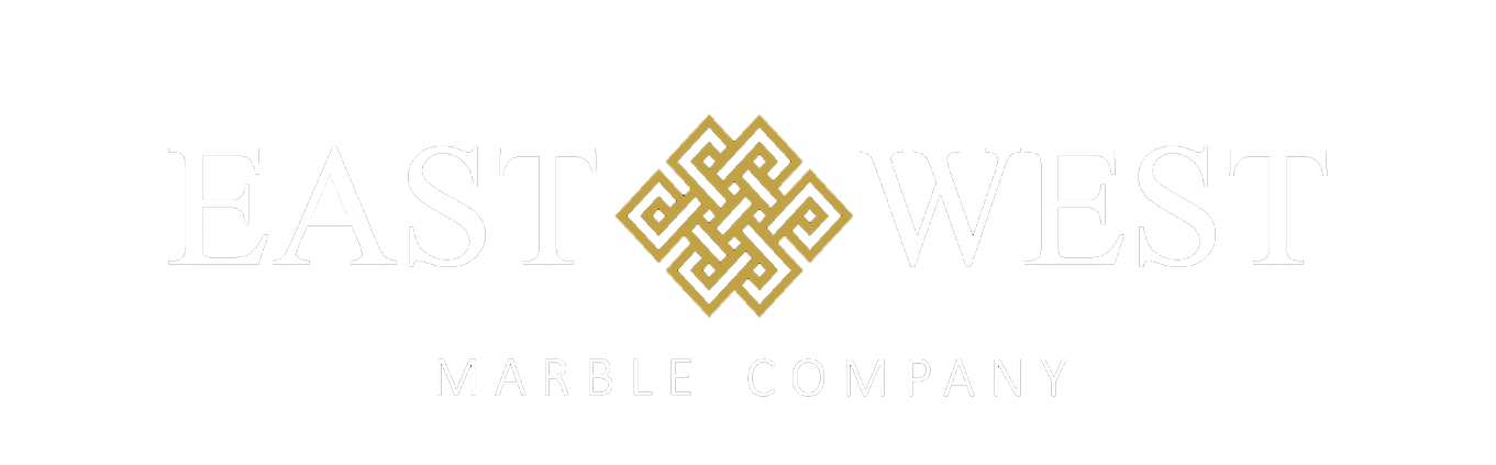 East West Marble Company logo on a green background with white lettering and a gold interwoven knot symbol between East and West.